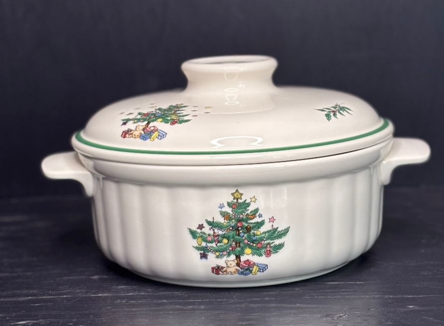 Ceramic casserole dish with Christmas tree design on a dark background