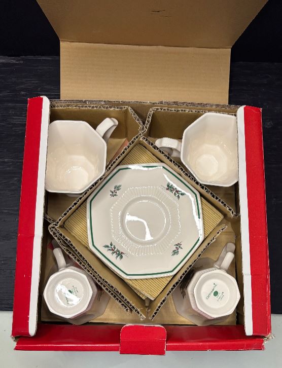 Ceramic tea set with four cups and a saucer in a cardboard box.