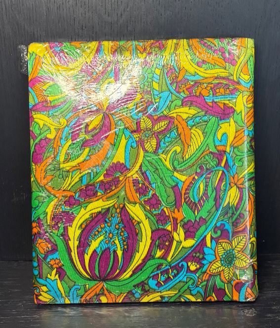 Colorful paisley-patterned product on a black background