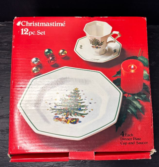Box of Christmastime 12-piece dinnerware set with Christmas tree design on a red background.