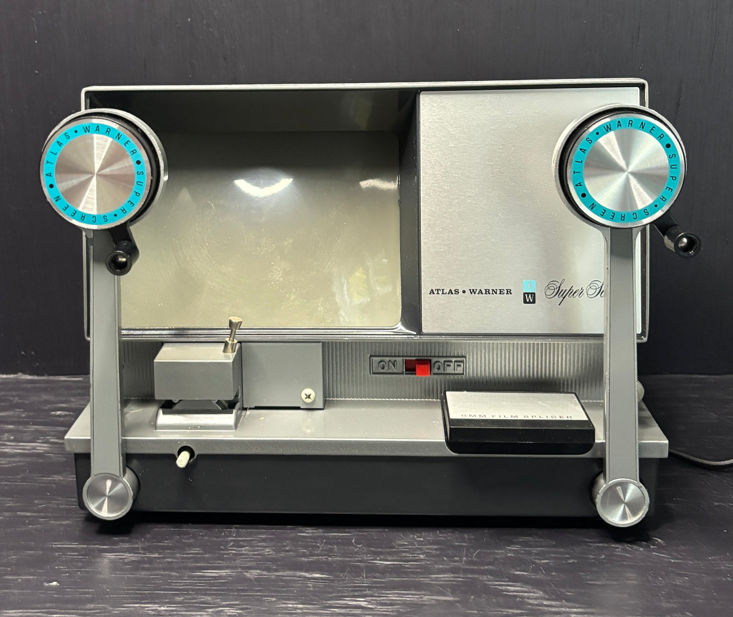 Vintage Atlas Warner Super 8 film projector on a dark background