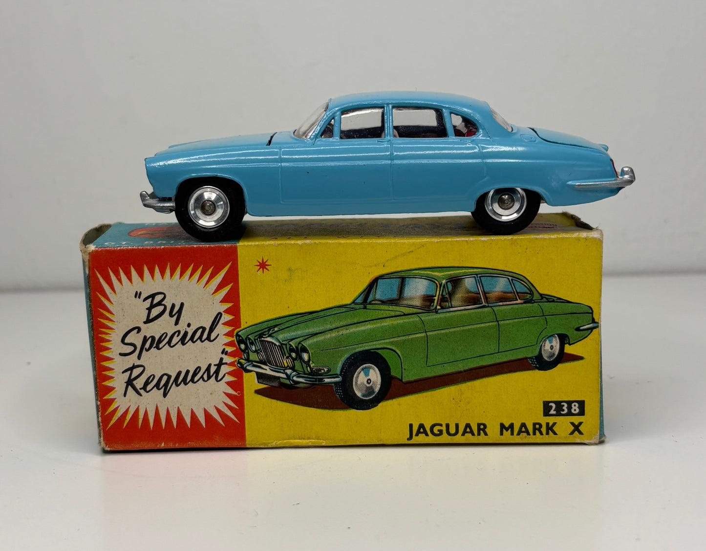Model car on top of its box with a Jaguar Mark X illustration and text 'By Special Request' on a gray background.