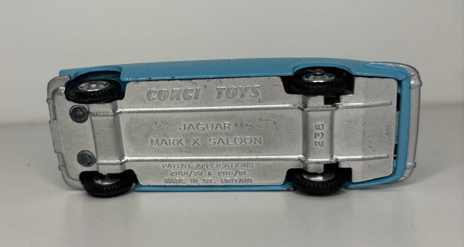Model car toy with 'Corgi Toys' branding on a gray background