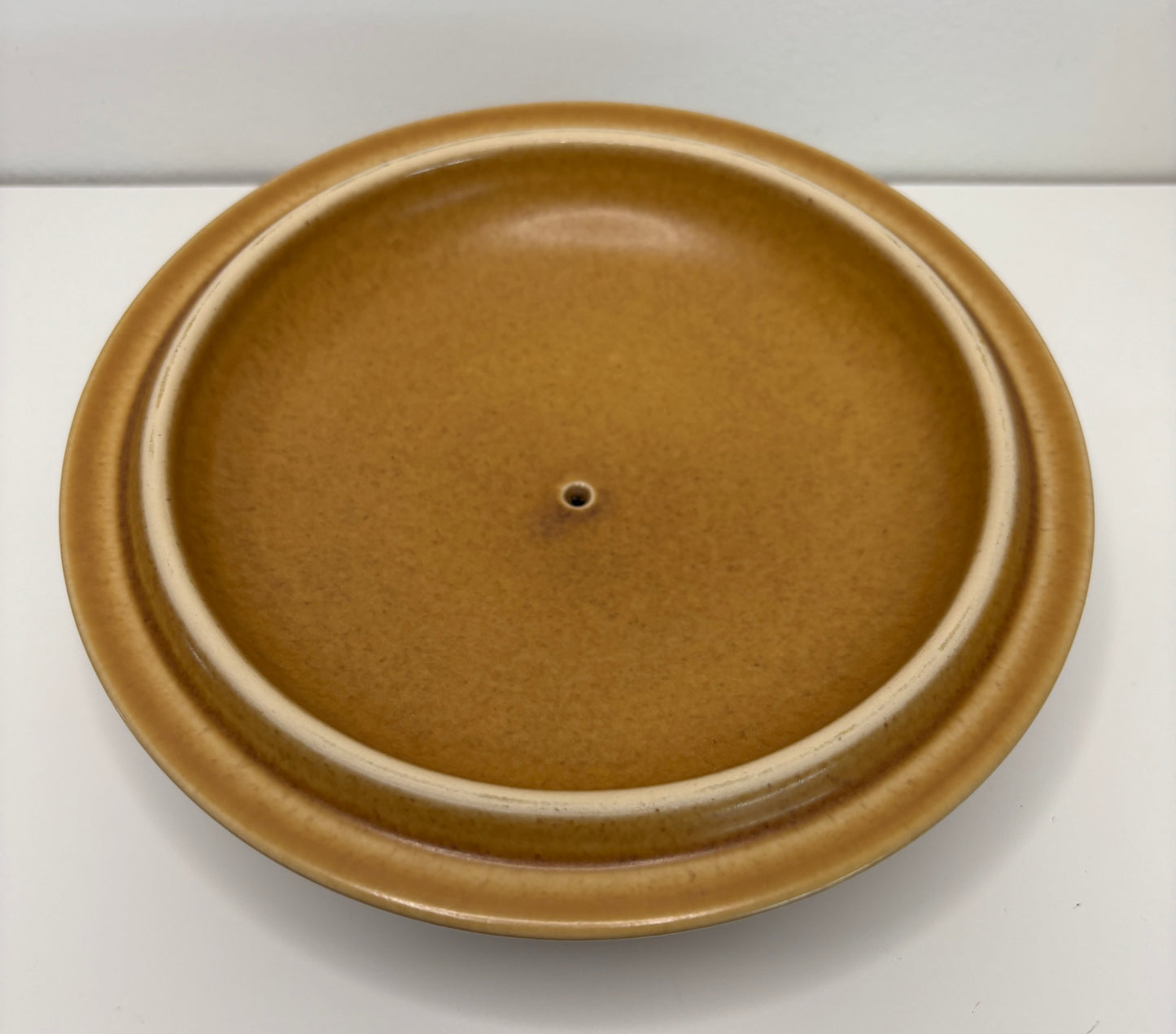 Brown ceramic lid on a white background