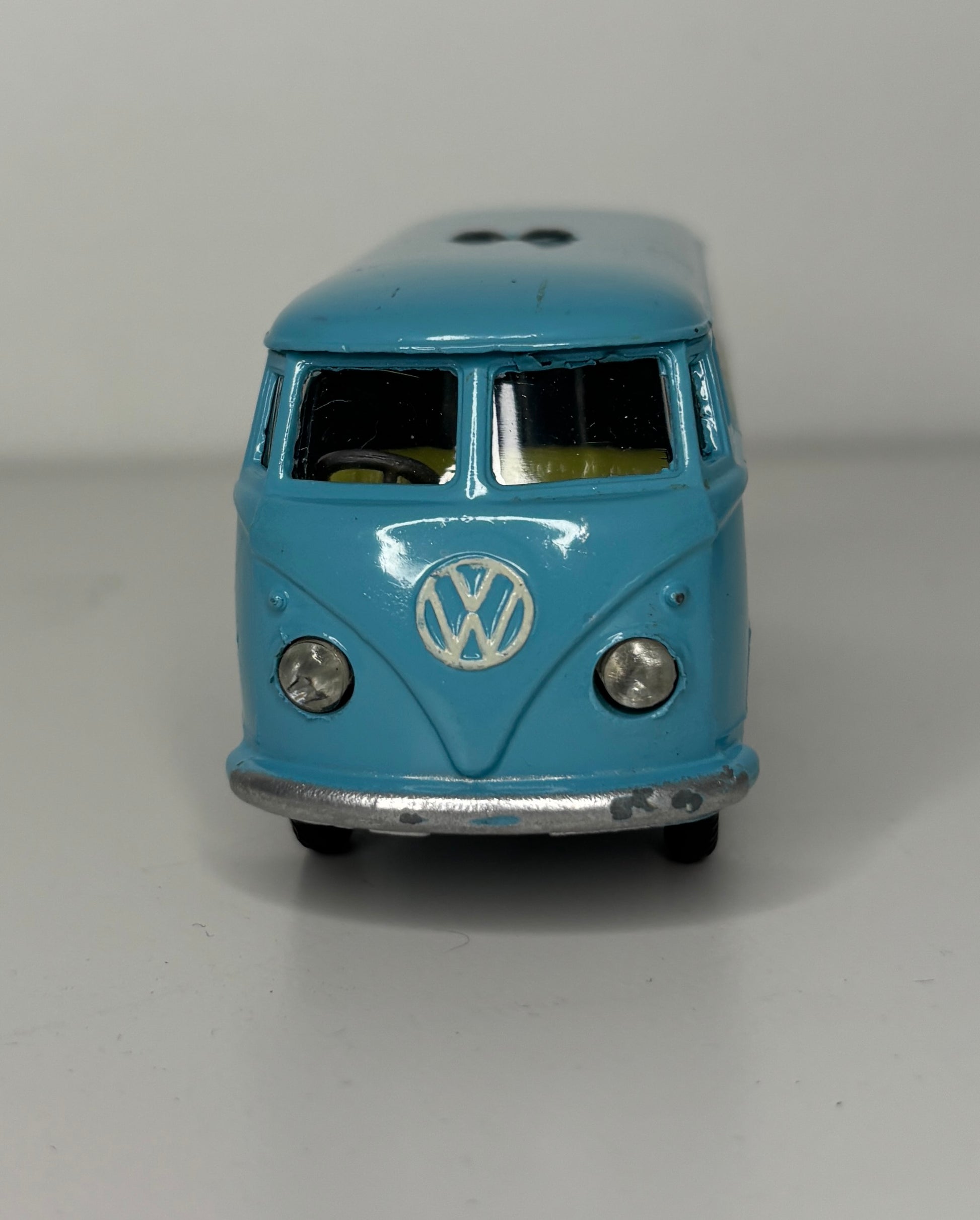 Model of a blue Volkswagen van on a gray background