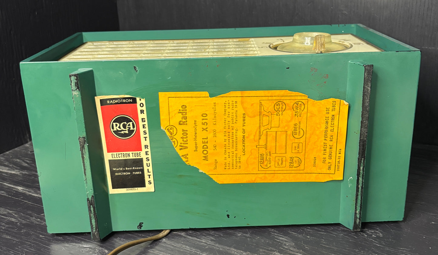 Vintage green radio with RCA label on a dark surface