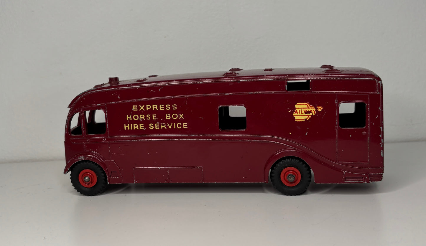 Model of a vintage express horse box hire service vehicle on a gray background