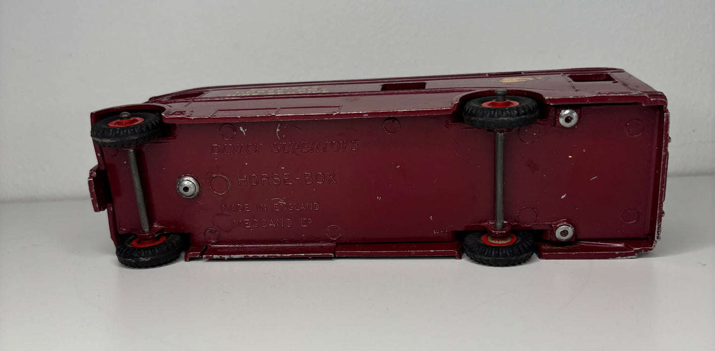 Maroon toy truck with visible branding on a white background