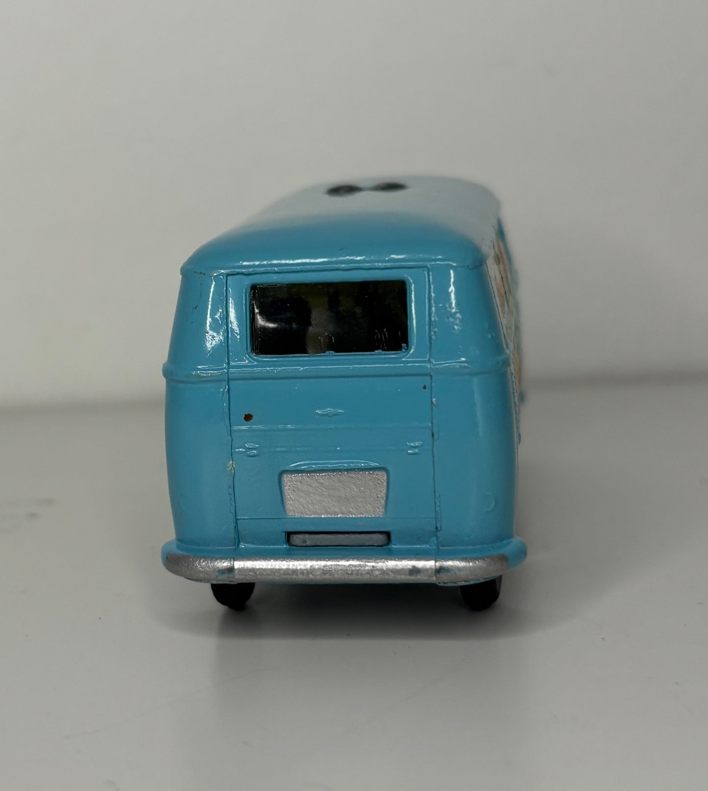 Model of a blue and white bus on a gray background