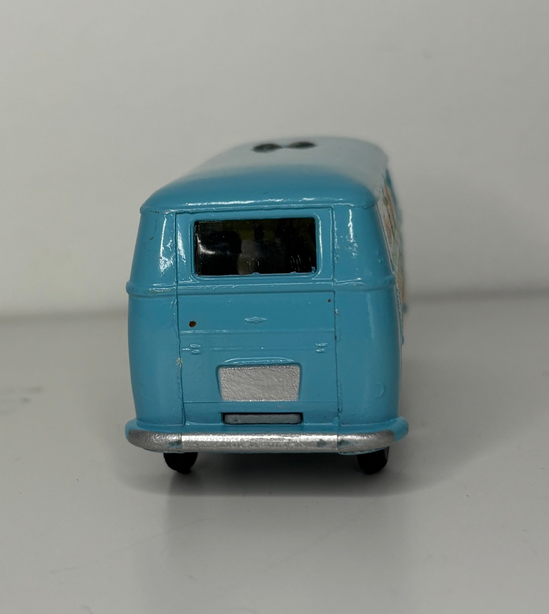 Model of a blue and white bus on a gray background
