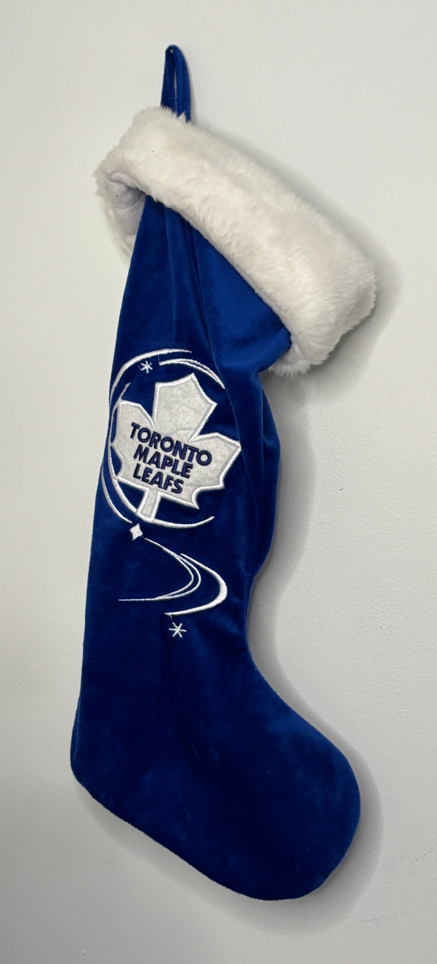 Blue Christmas stocking with white fur trim featuring the Toronto Maple Leafs logo on a light gray background.