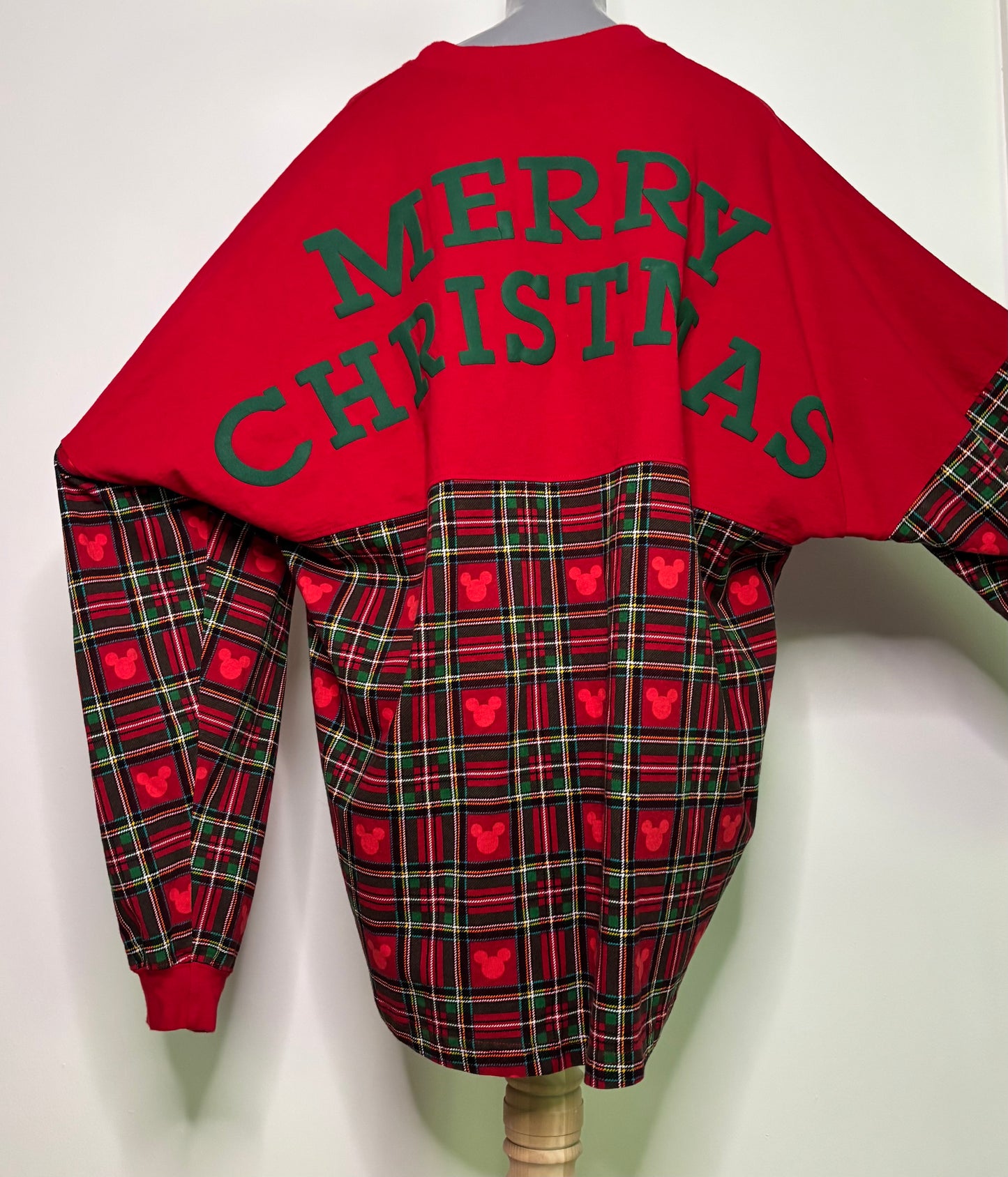 Red and plaid Christmas-themed outfit with 'Merry Christmas' text on a white background