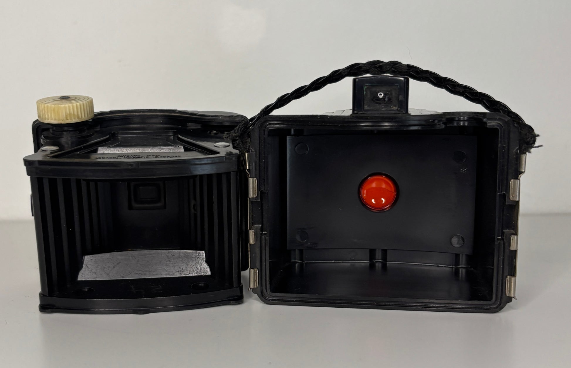 Black box camera with open lid on a white background