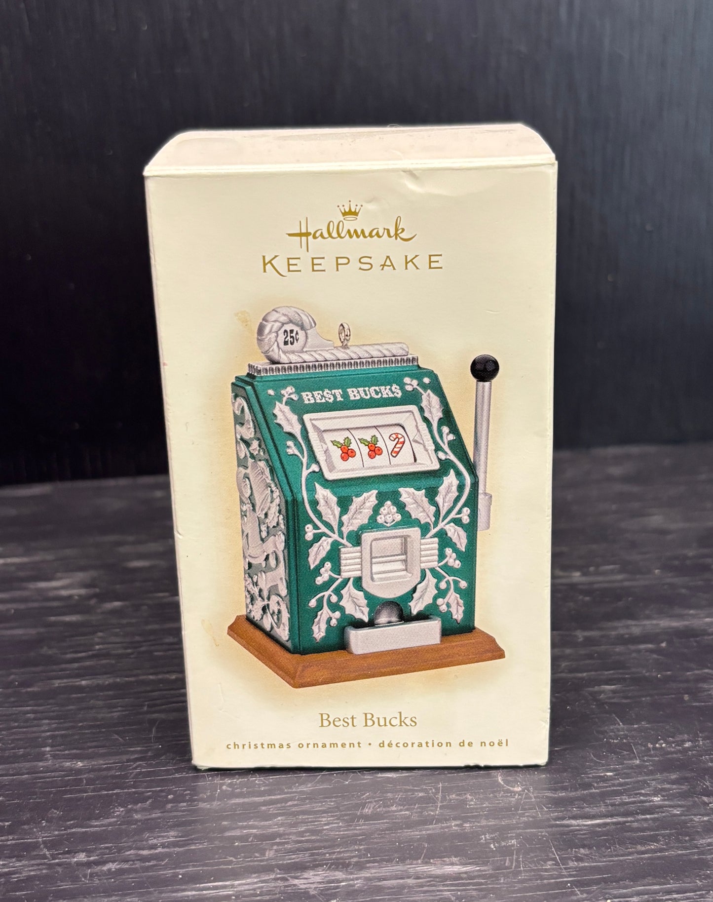 Hallmark Keepsake Christmas ornament packaging with slot machine design on a dark surface.