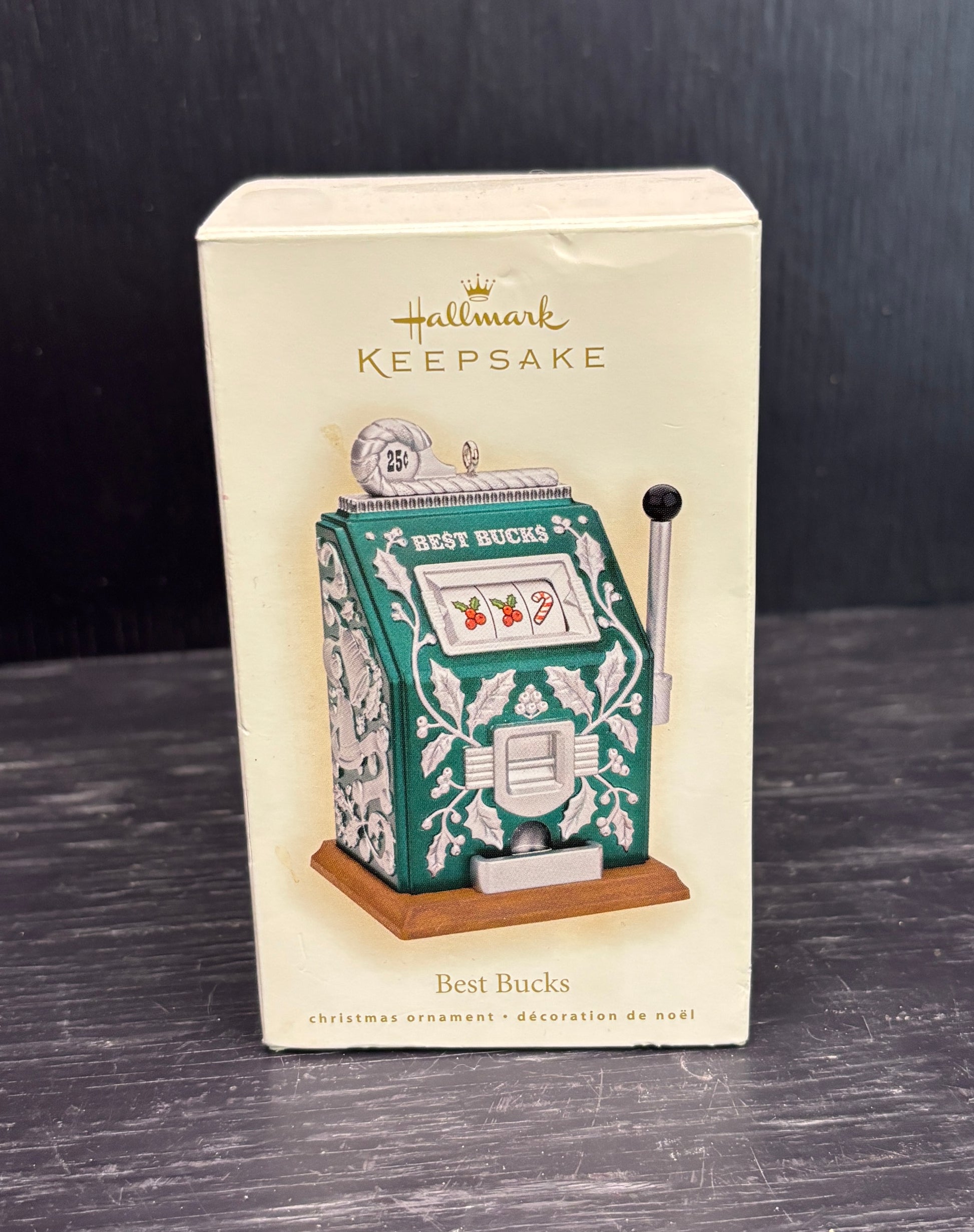 Hallmark Keepsake Christmas ornament packaging with slot machine design on a dark surface.