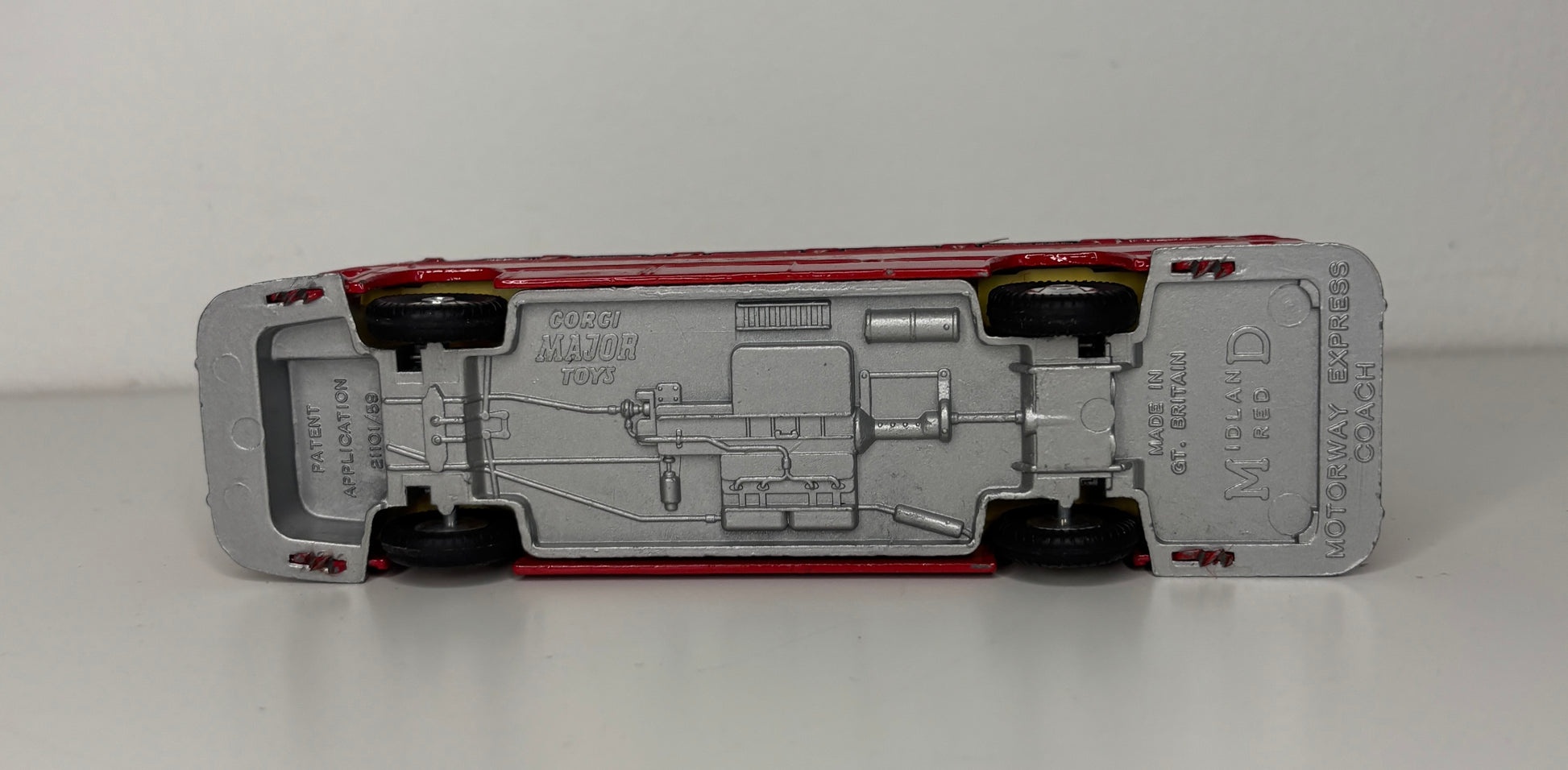 Model car chassis with visible branding on a white background