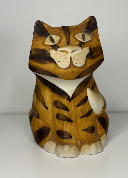 Wooden cat figurine with a striped pattern on a white background
