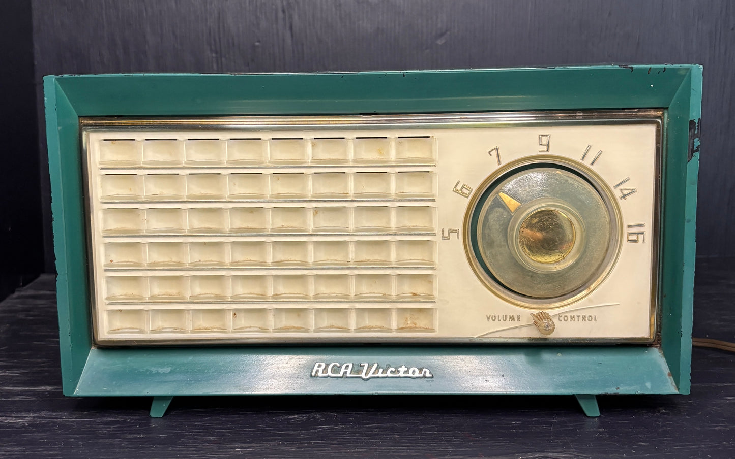 Vintage RCA Victor radio with teal frame on a dark background