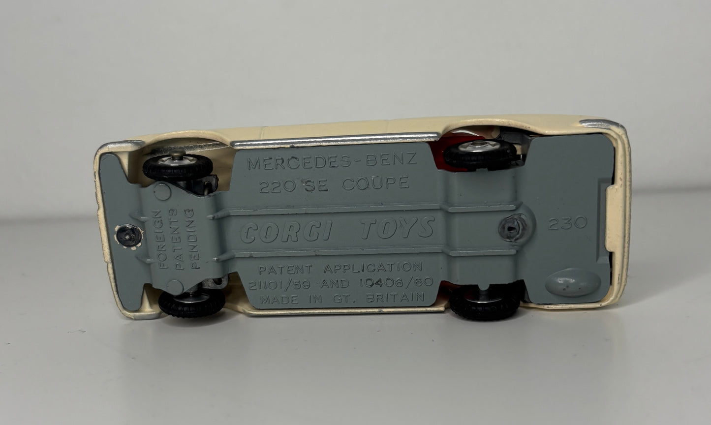Back view of a Corgi Toys Mercedes-Benz 220SE Coupe model car on a gray background