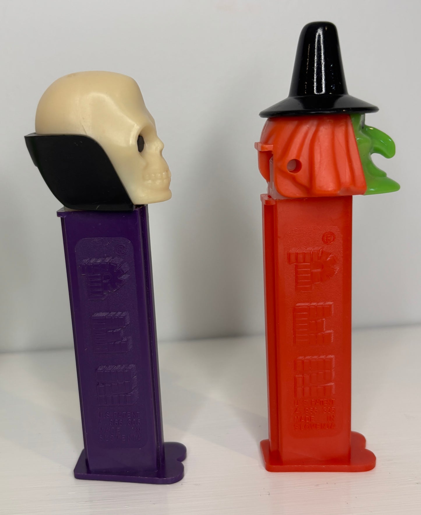 Two Halloween-themed PEZ dispensers on a white background