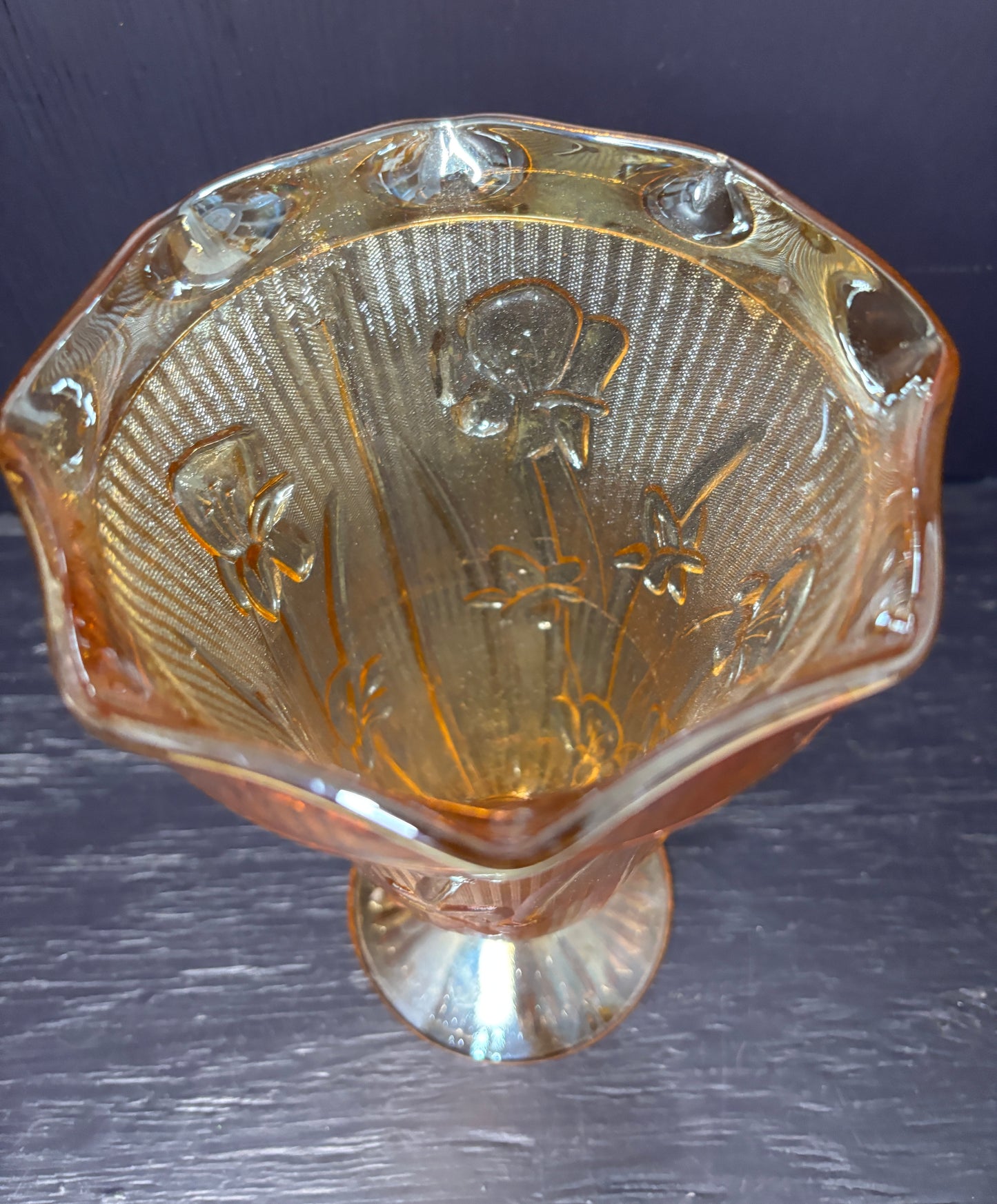 Decorative glass bowl with playing card suits on a dark surface