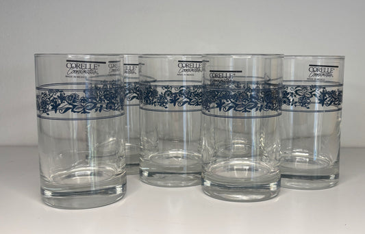 Set of five Corelle glasses with blue floral patterns on a white background