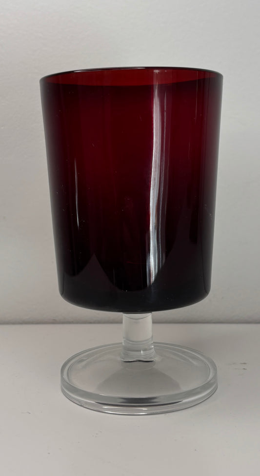 Red glass goblet on a white background