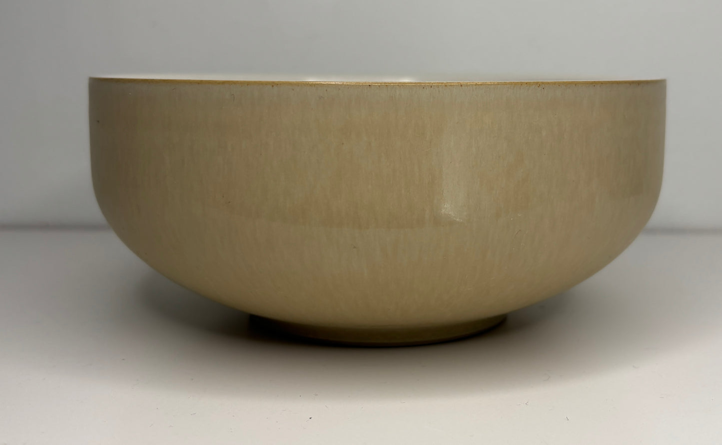 Beige ceramic bowl on a white background