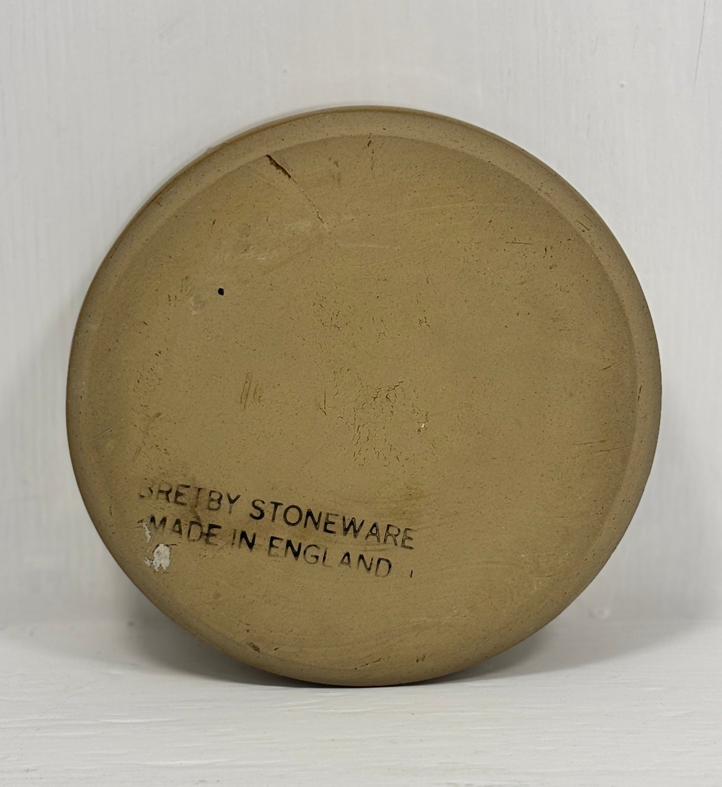 Round stoneware plate with 'Sheffield Stoneware Made in England' text on a white background
