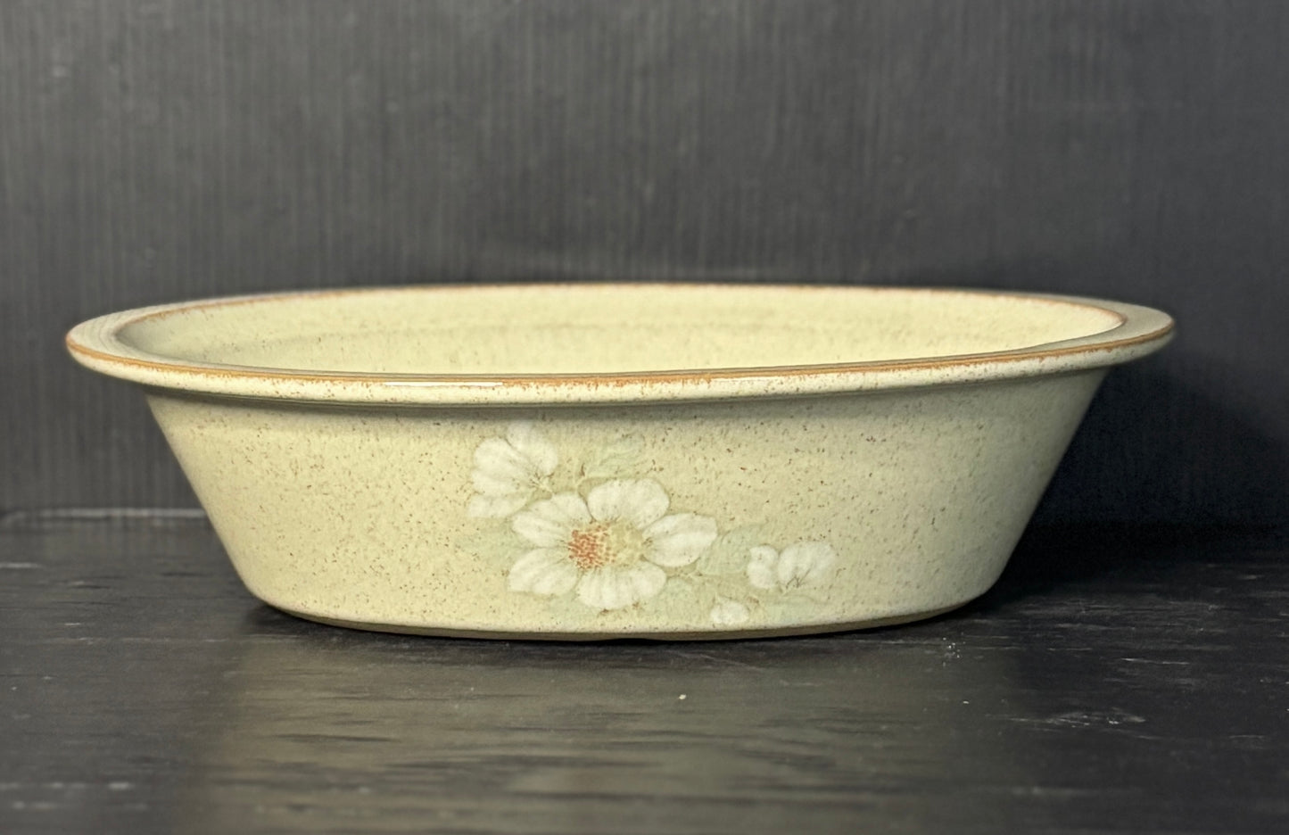 Ceramic bowl with floral design on a dark surface