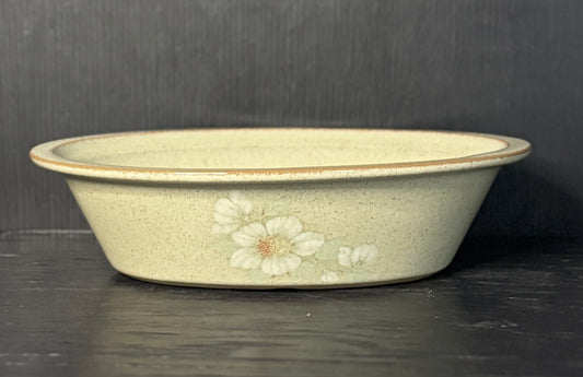 Ceramic bowl with floral design on a dark surface