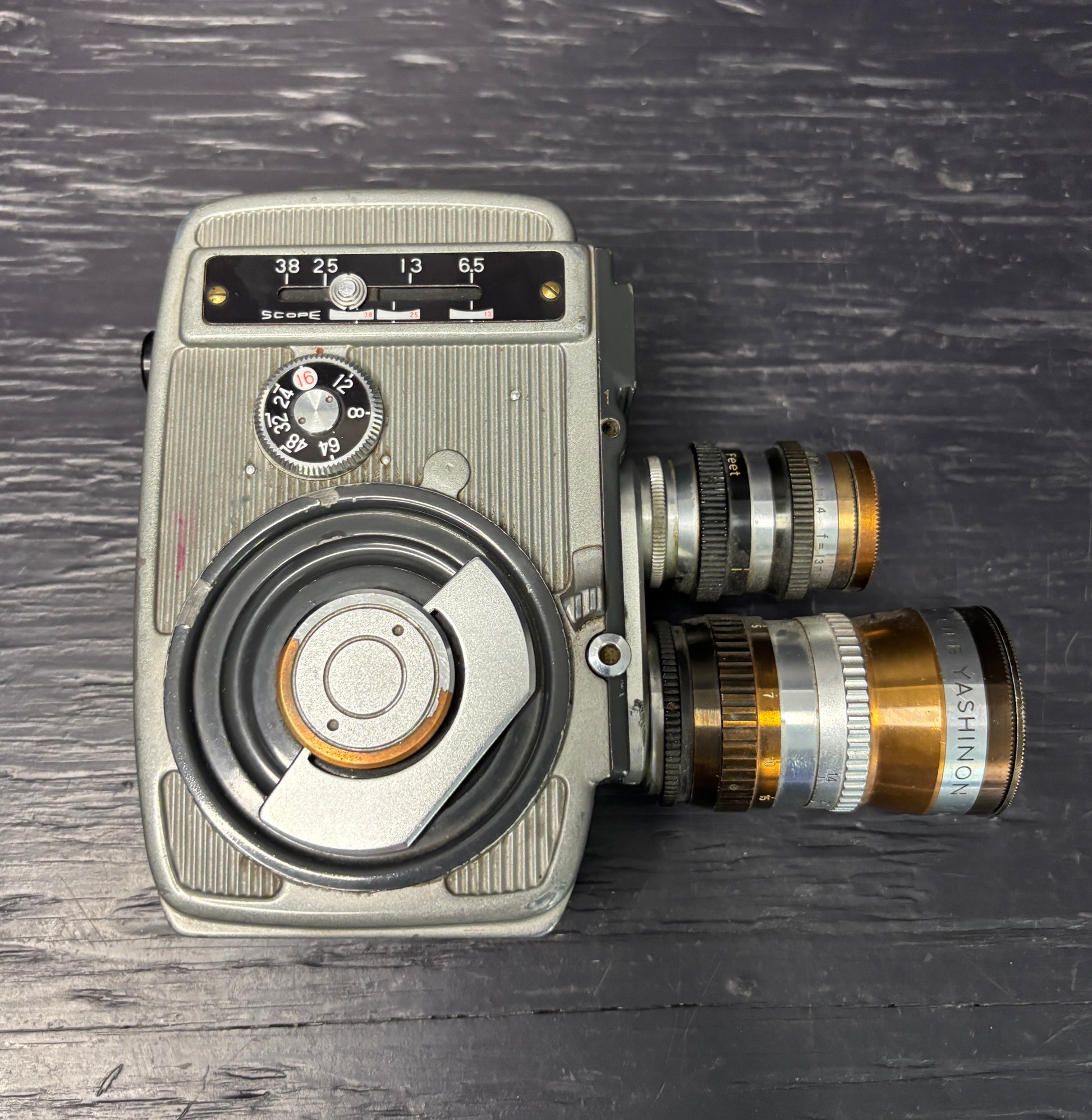 Vintage movie camera on a textured dark surface