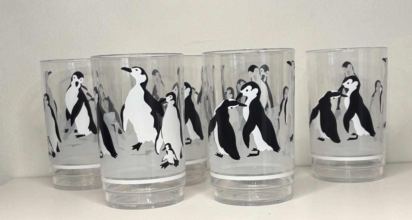 Set of 6 glass tumblers with penguin designs on a white background