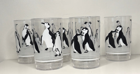 Set of 6 glass tumblers with penguin designs on a white background