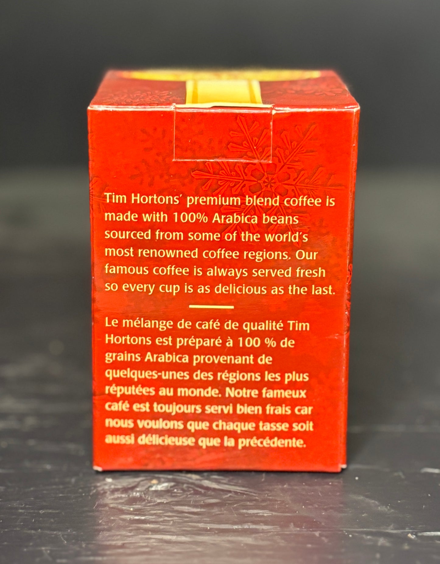 Red Tim Hortons coffee package with text on a dark background