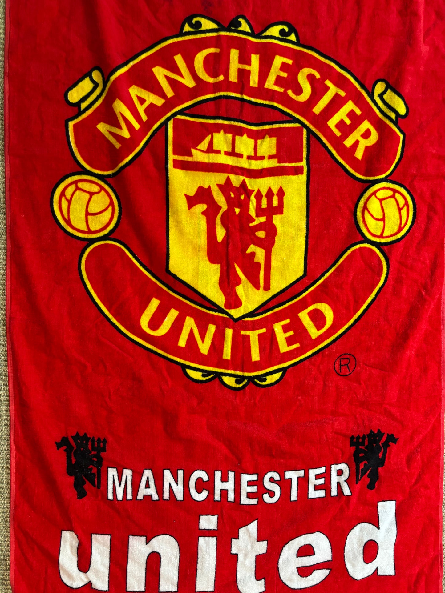 Manchester United logo on a red background