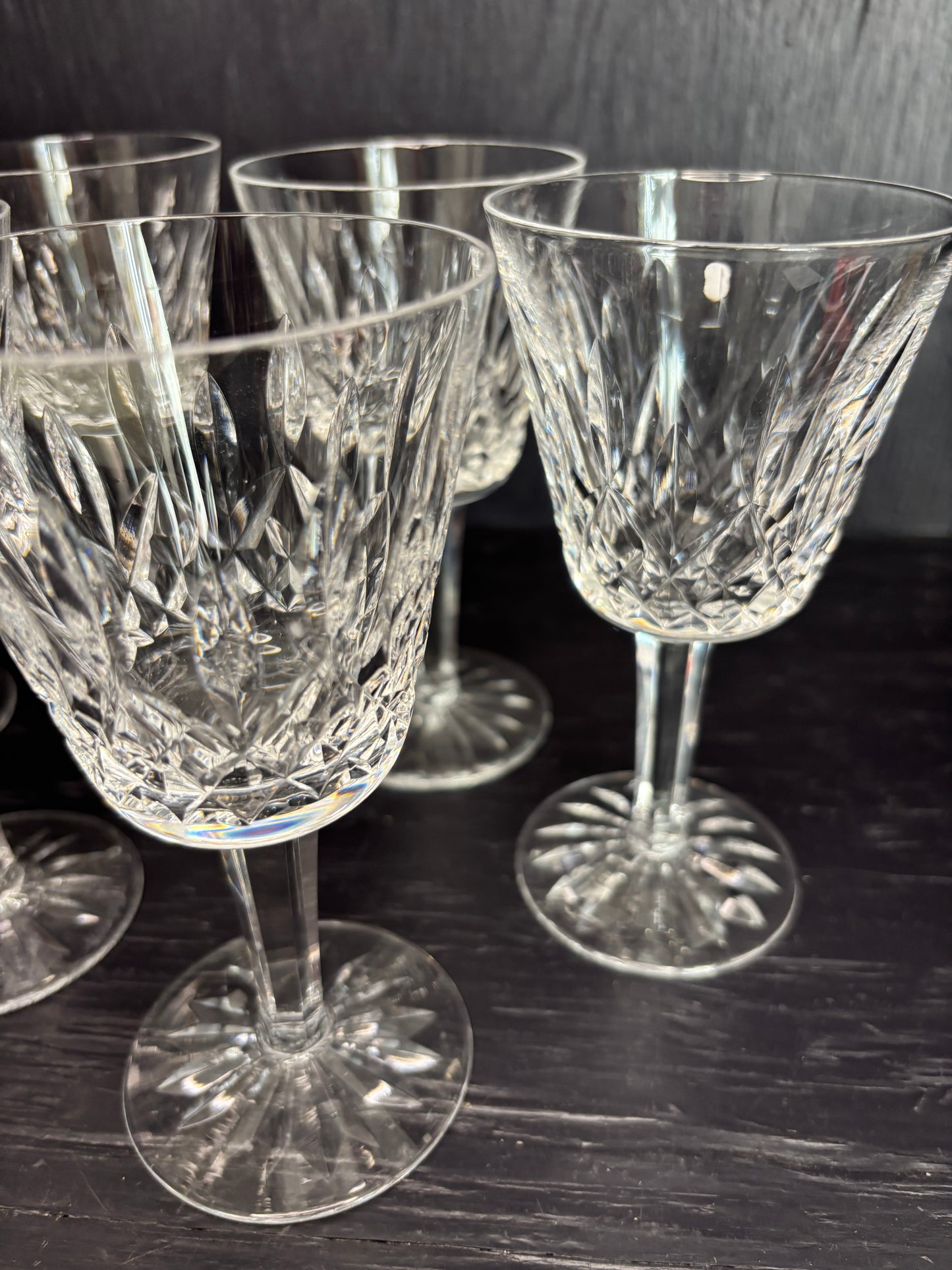 Set of crystal glasses on a reflective black surface