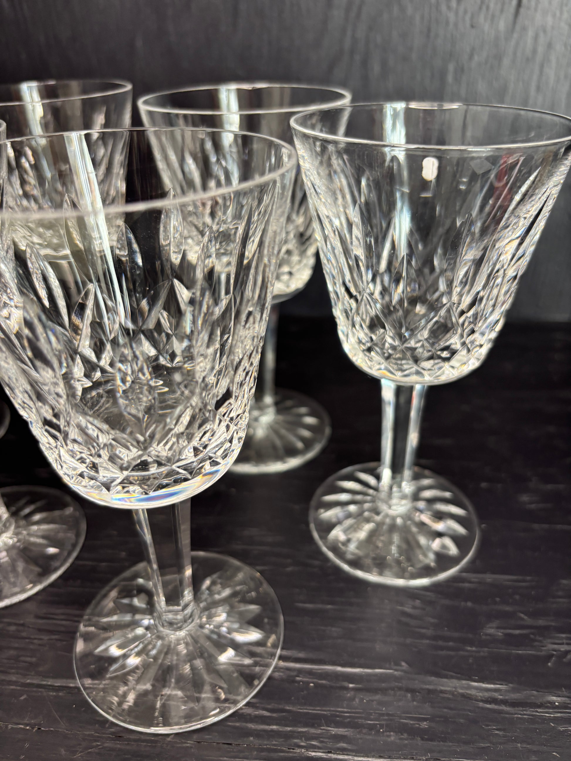 Set of crystal glasses on a reflective black surface