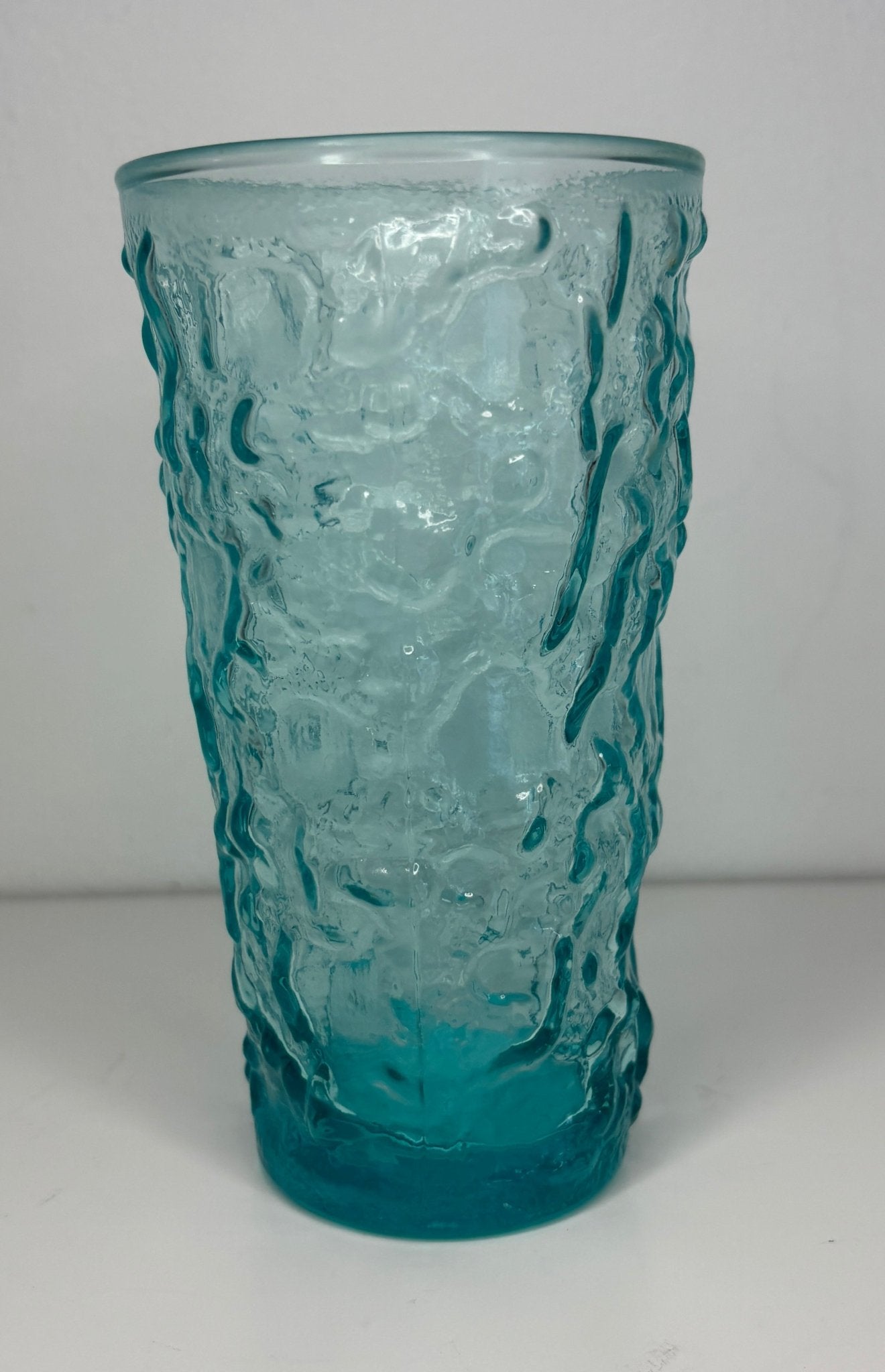 Textured blue glass glass on a white background
