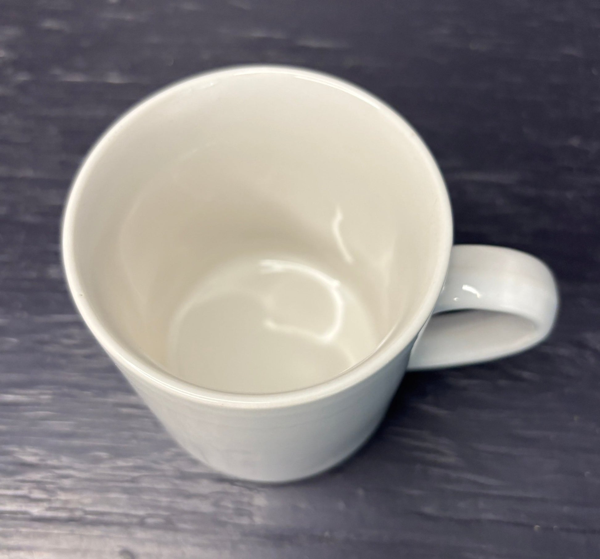White ceramic mug on a dark gray surface