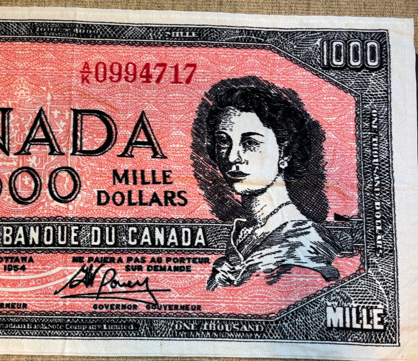 a towel shaped like a Canadian $1000 Bill