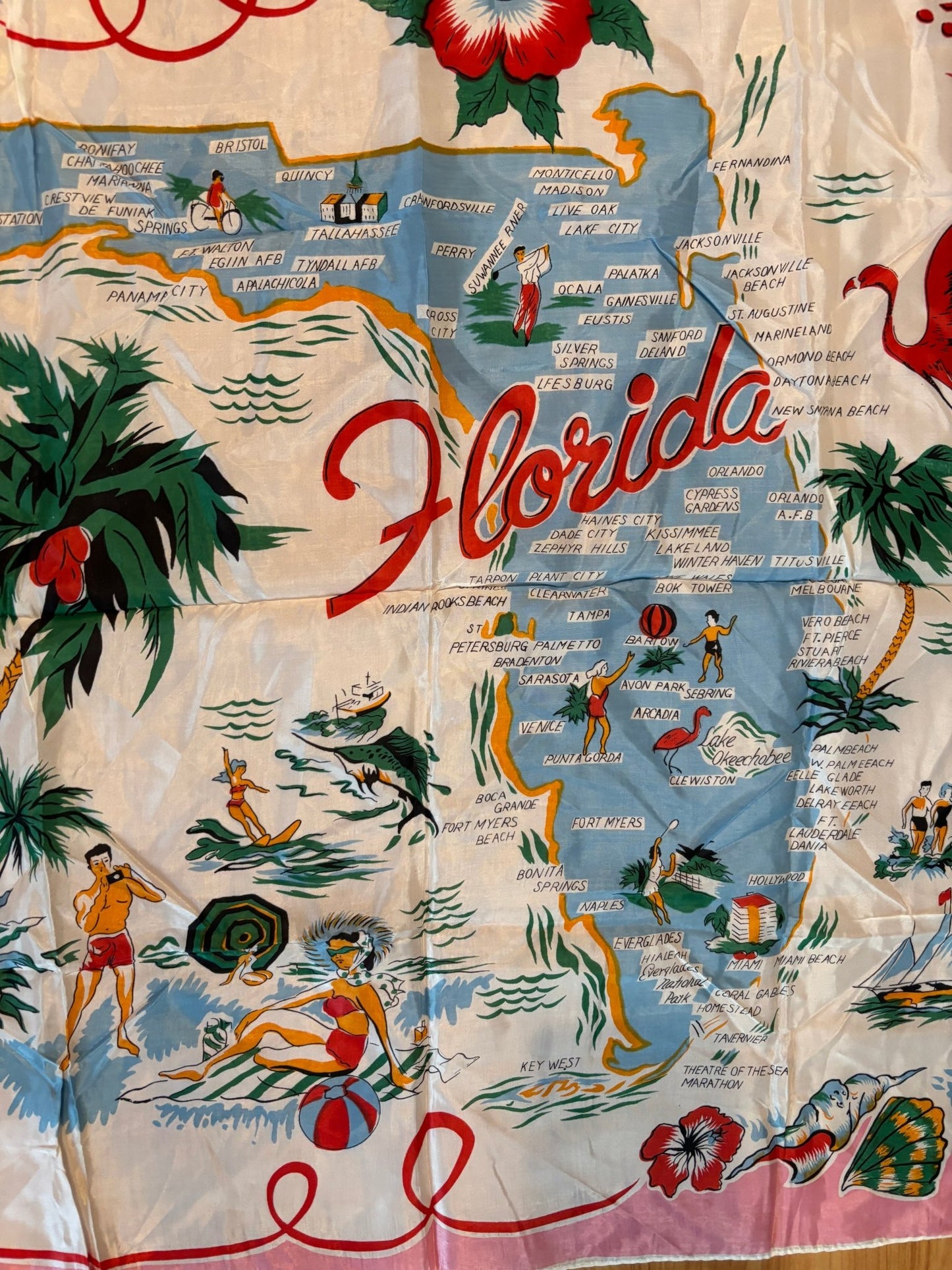 pink Florida Souvenir Scarf with images of Florida, beaches, landmarks, trees and birds.
