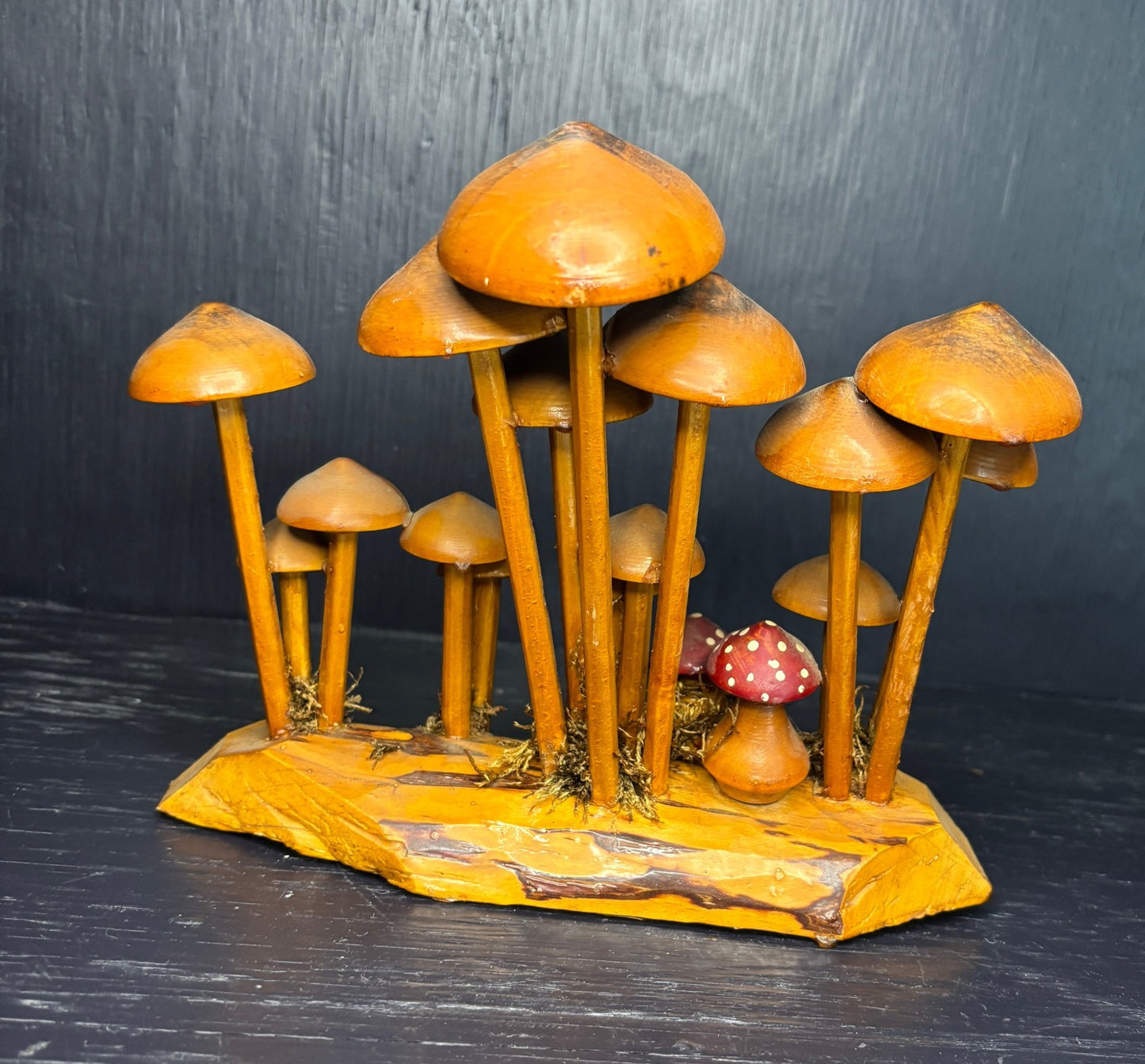 Wooden mushroom sculpture on a dark background