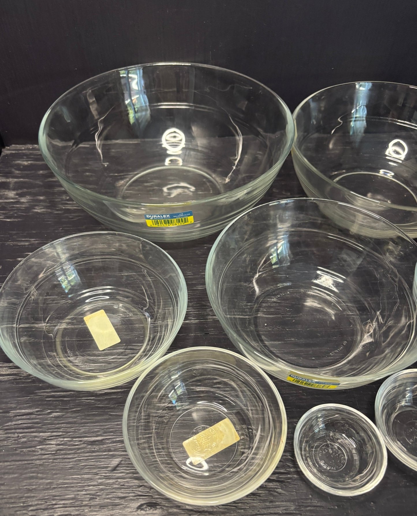 Set of clear glass bowls on a dark surface