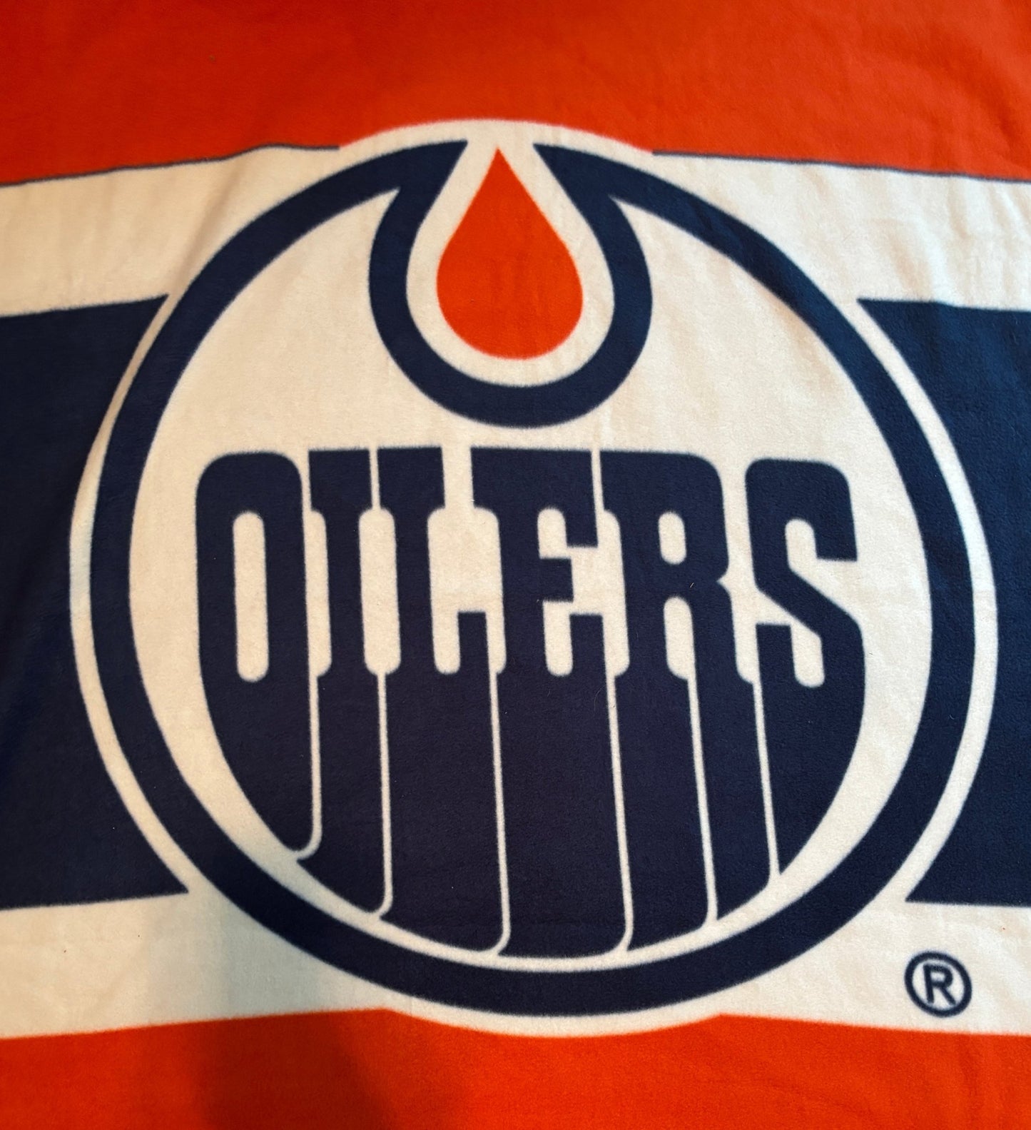 Edmonton Oilers logo on a red and blue background