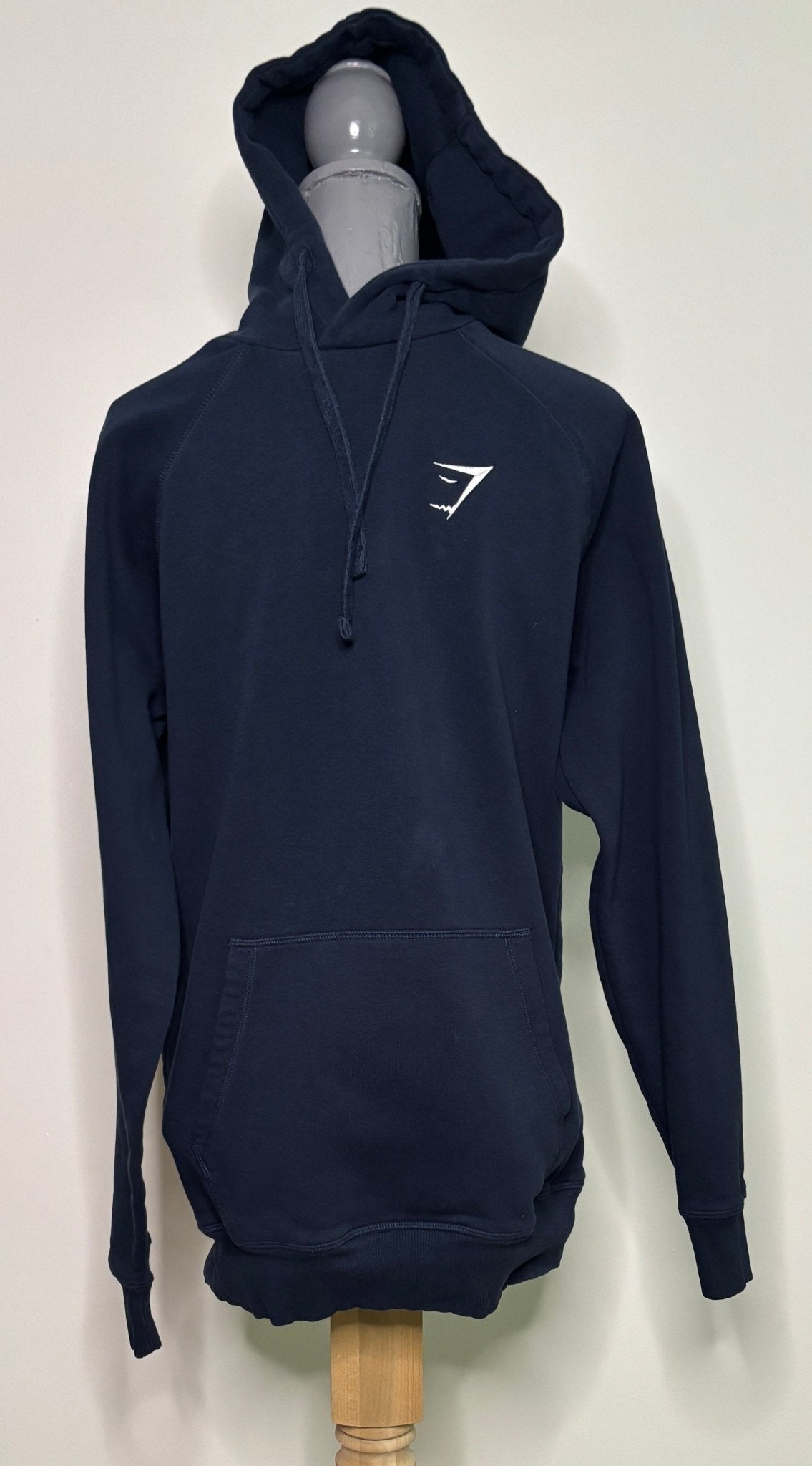 Navy blue hoodie with a logo on a mannequin against a white background