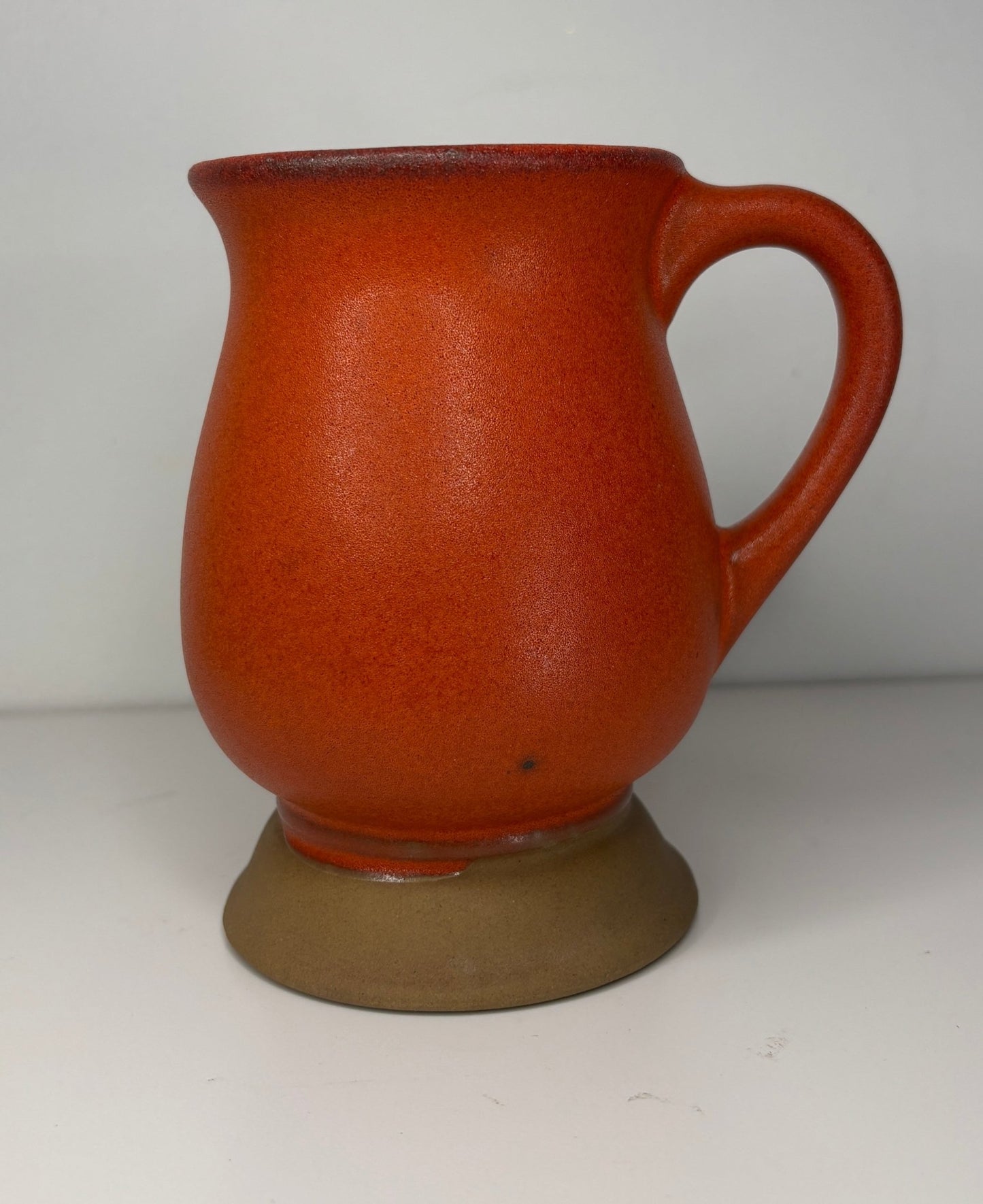 Red ceramic mug on a white background