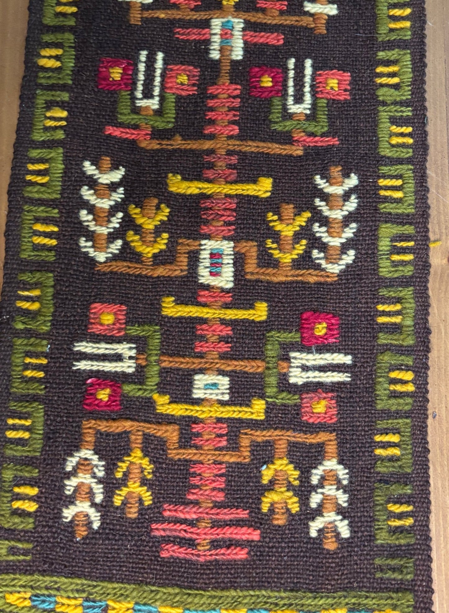 Textile with intricate patterns and colors on a dark background