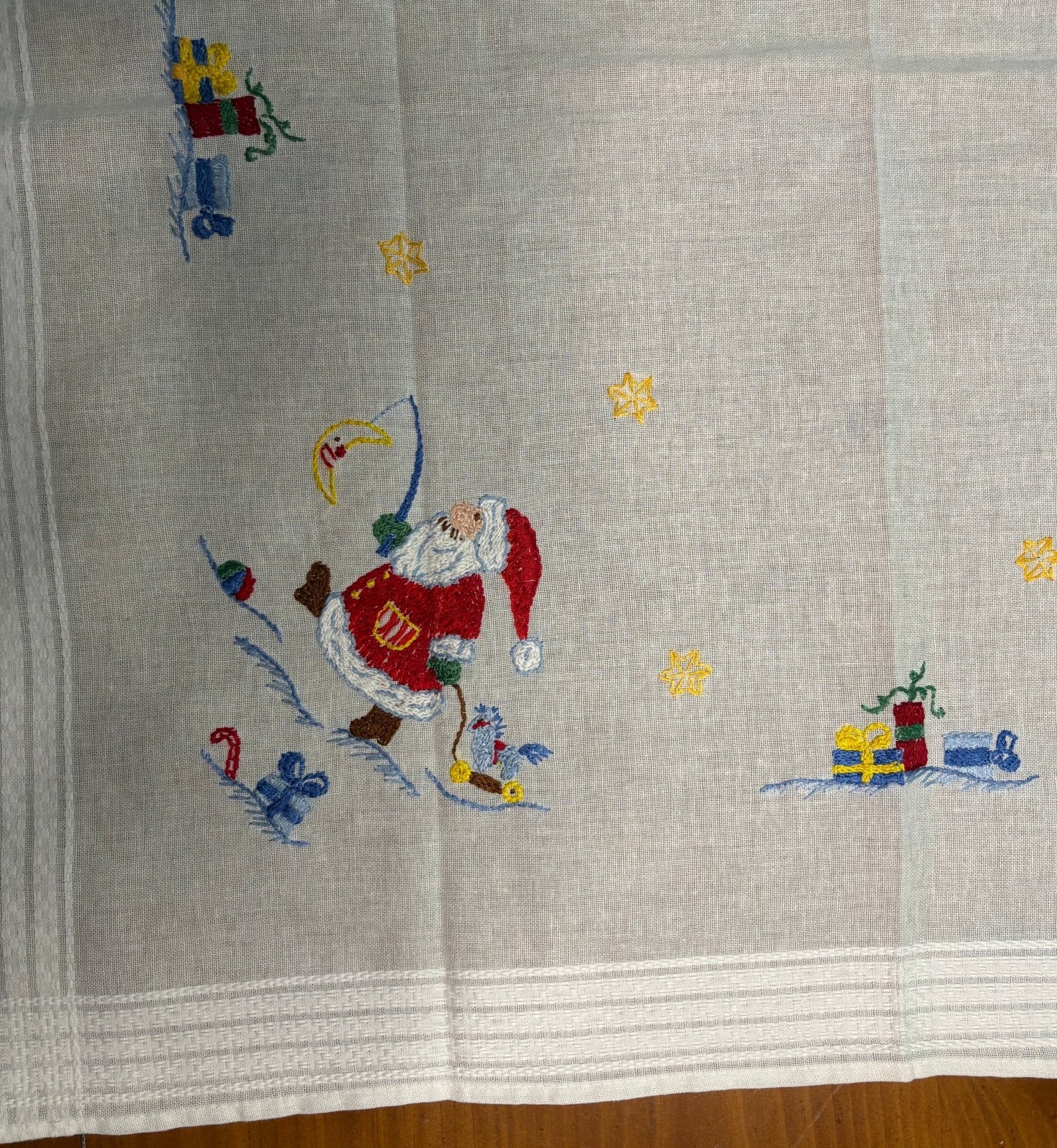 Embroidered fabric with Santa Claus design on a gray background