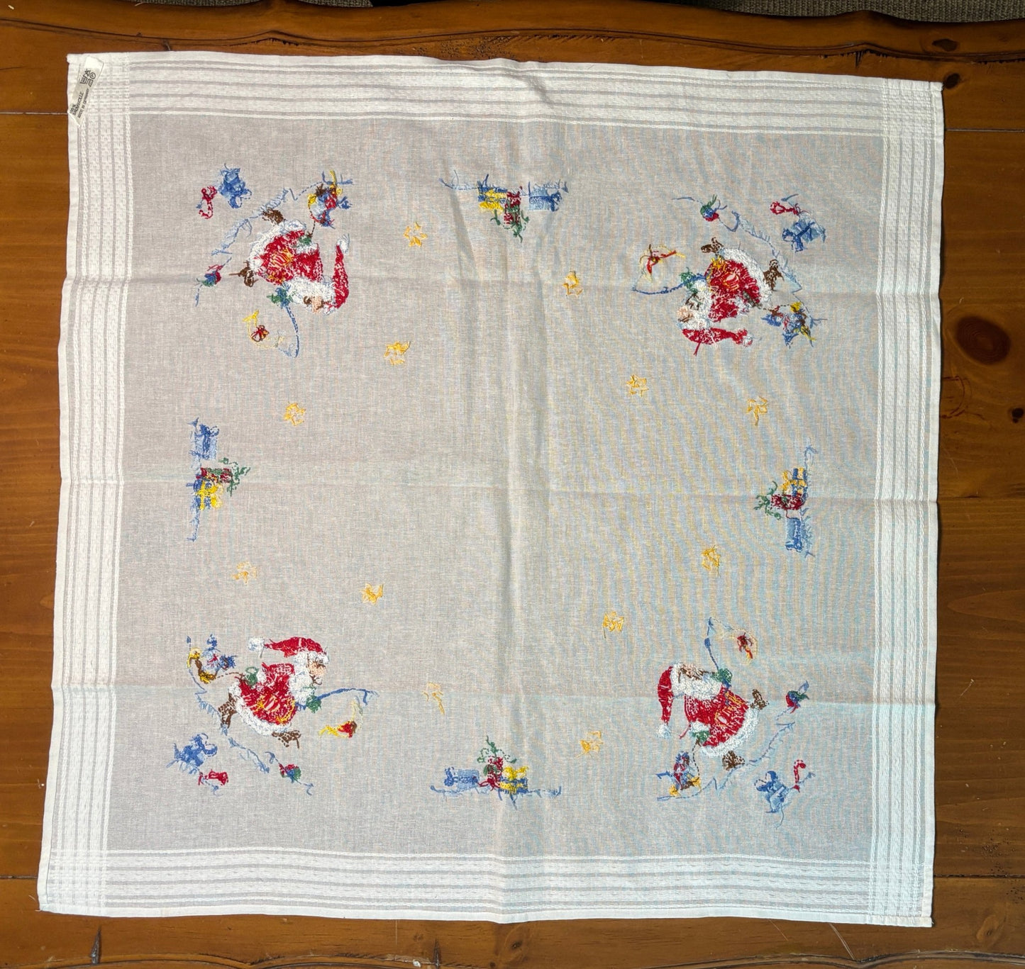 Embroidered fabric with floral patterns on a wooden surface